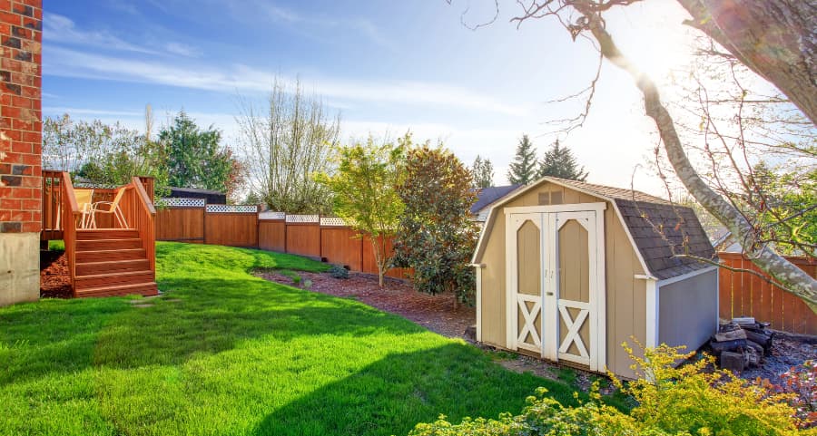 Fenced backyard with storage shed in The Woodlands